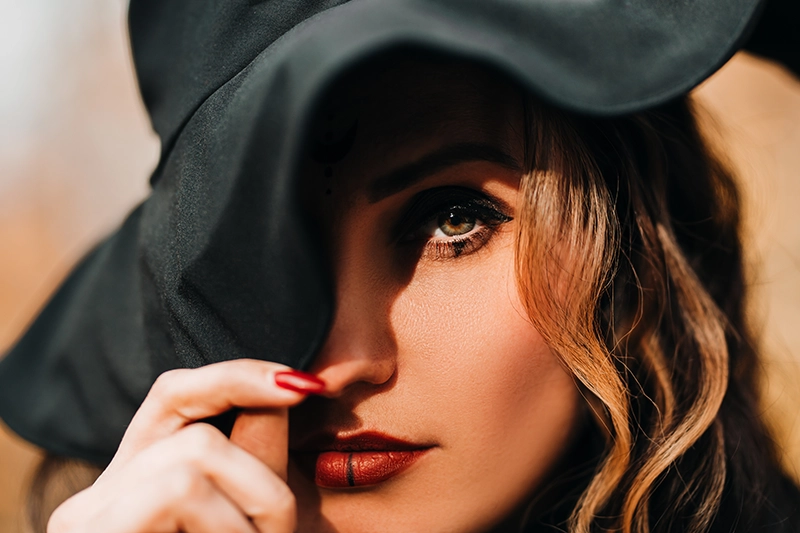 Chica con sombrero cubriendo parte de la cara.